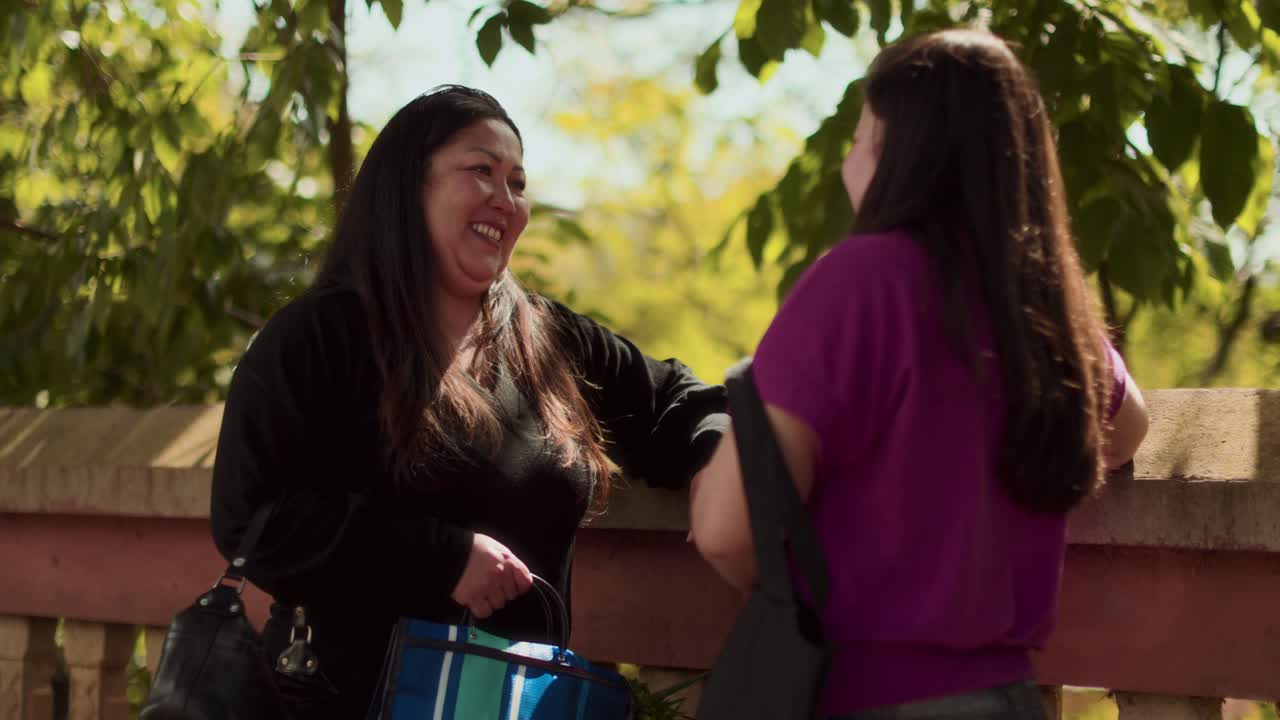 Two women having a friendly conversation outdoors