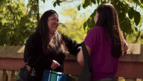 two women having a friendly conversation outdoors