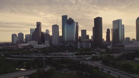 aerial -steady shot of houston skyline at sunrise with traffic