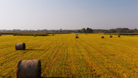 Yellow-field-with-hay-and-hay-bales-after-the-harvest-during-sunny-weather