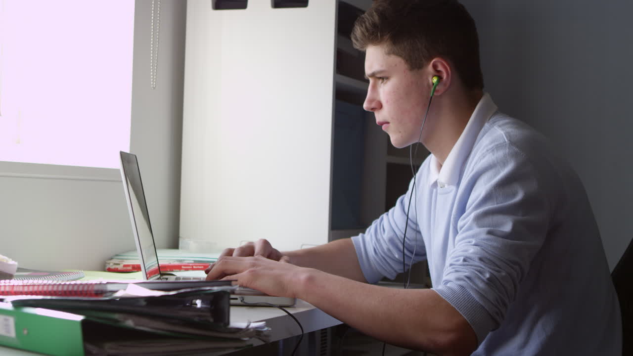 Teenage Boy Using Laptop And Listening To Music Shot On R3D
