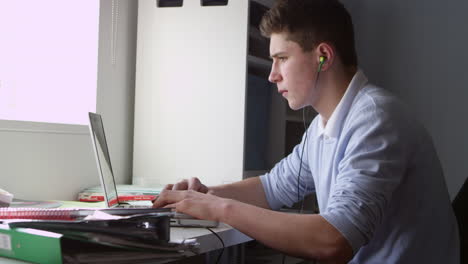 teenage boy using laptop and listening to music shot on r3d