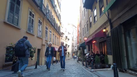 walking down a cobblestone street in a historic european city