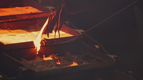 molten metal pouring into molds in a foundry