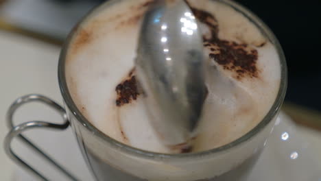 taking tasty foam from coffee