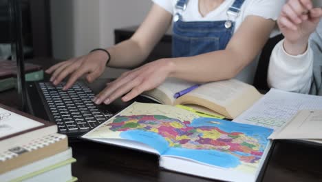 Studying-with-map-and-laptop