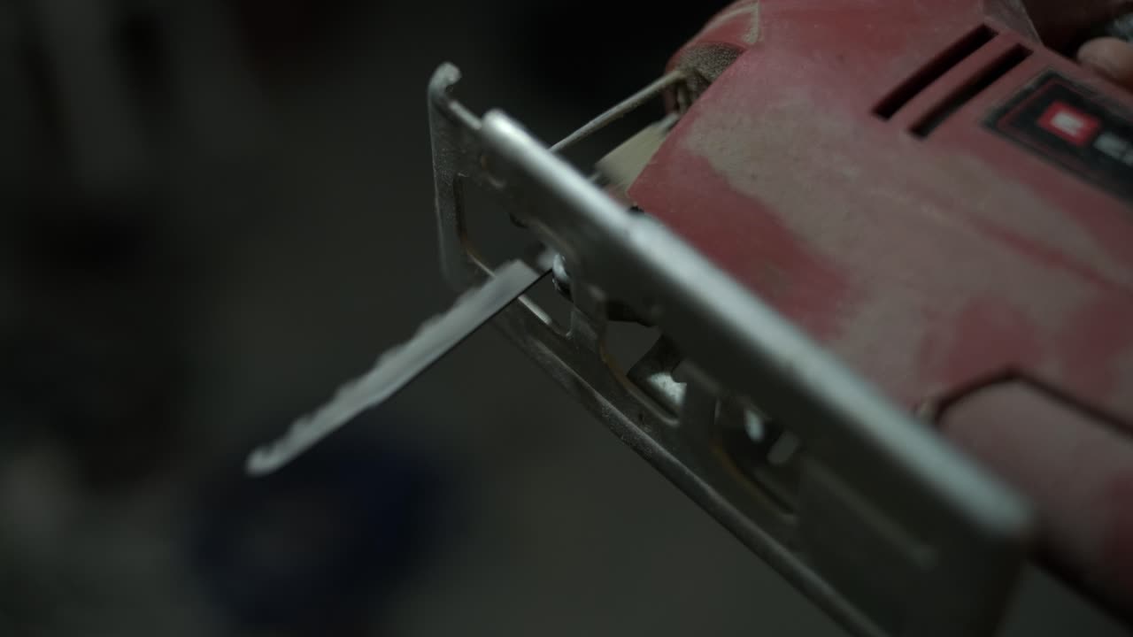 Close-up of an Electric Jigsaw Power Tool with a Moving Blade