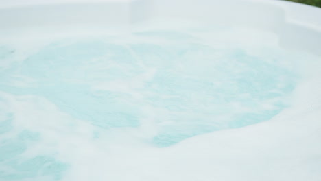 jacuzzi on bubbling in slow motion without any people in backyard