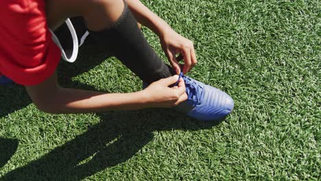 african american soccer kid lacing up his shoe