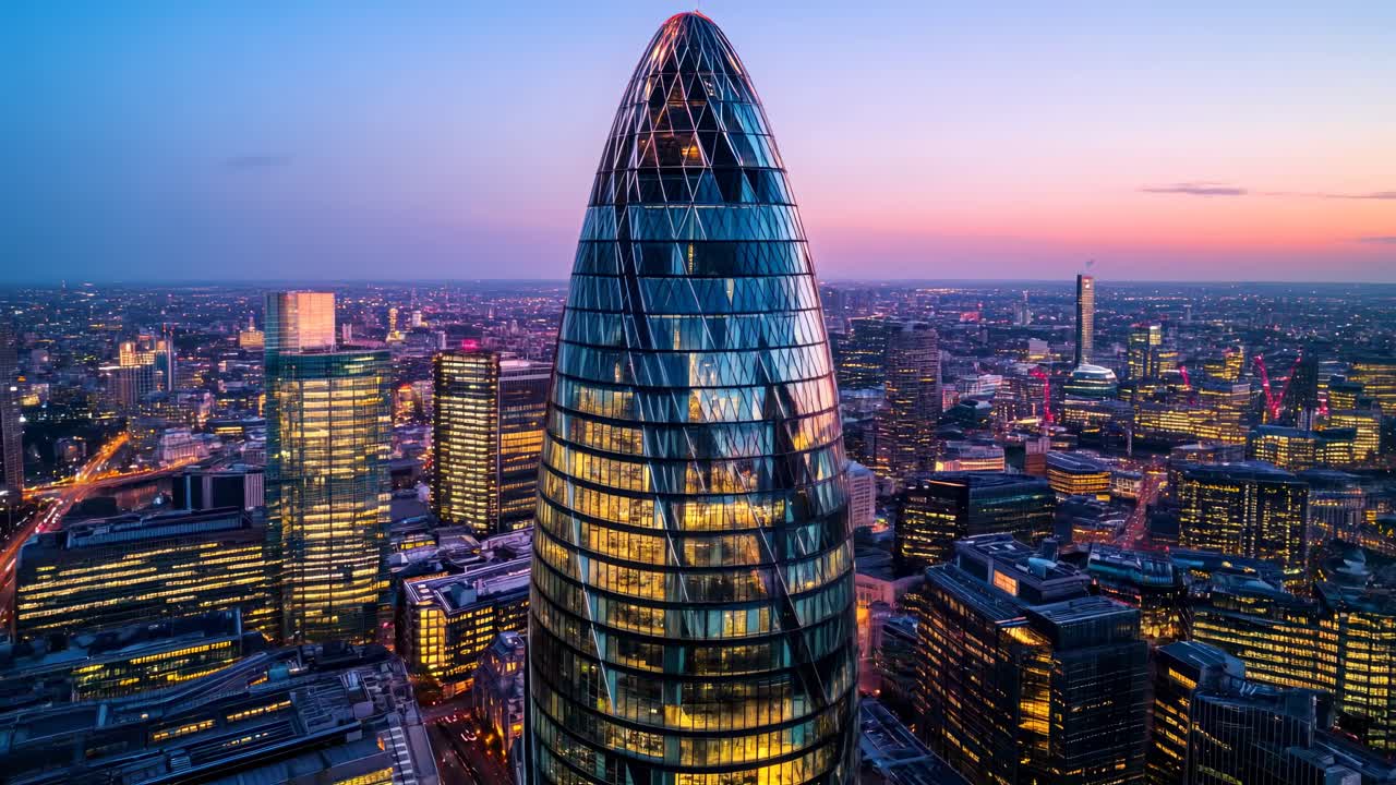 Aerial view of a modern cityscape at sunset, highlighting a futuristic skyscraper