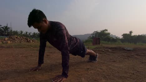 boy man doing push-ups in sand red soil moring sunrise workout exercise fitness