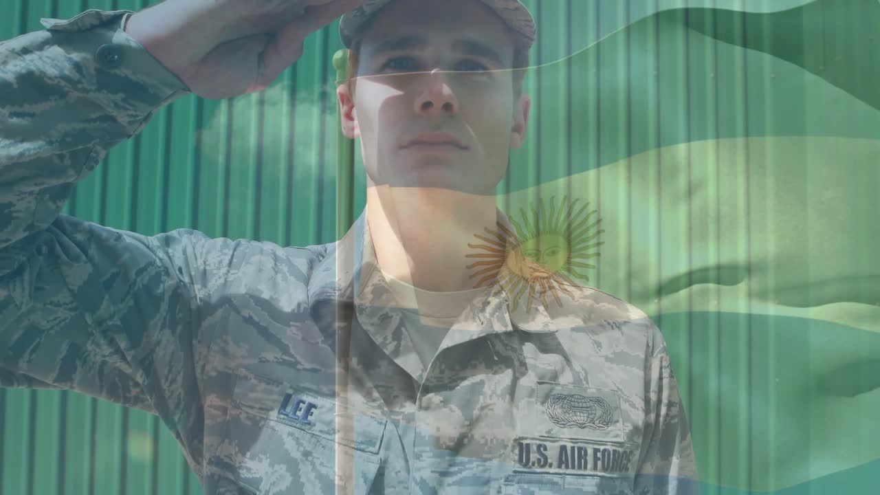 Male airman standing, tilting head then saluting, honoring flag with sun-emblem overlay drifting
