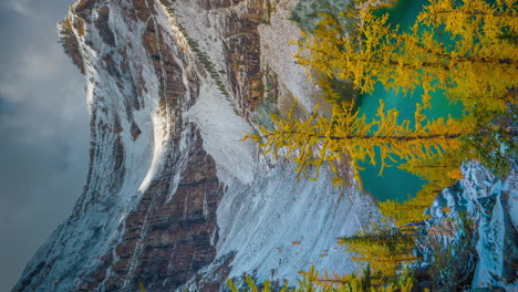 vertical 4k timelapse, clouds shadows moving above snow capped peaks, glacier and lake