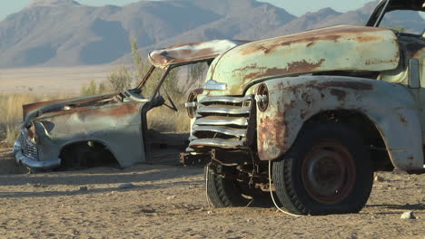 rusty abandoned cars in the desert. locked off