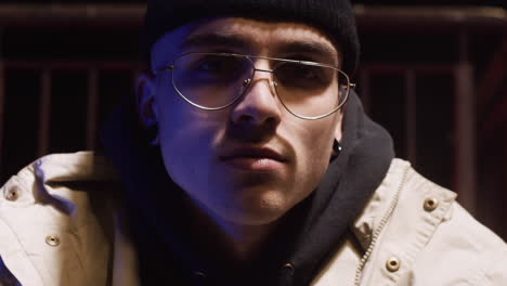 close-up portrait of a young man at night