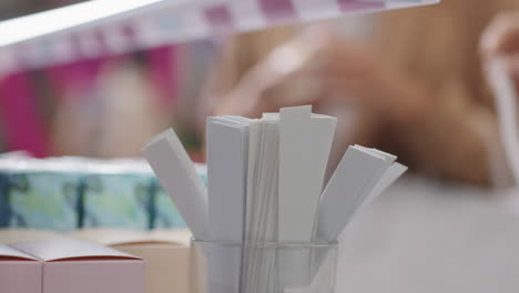 female hands taking perfume blotter