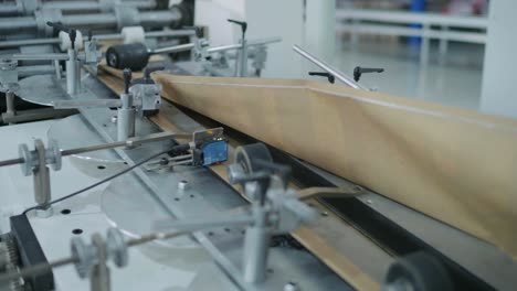 sheets of paper or material being fed into rollers at a printing factory in karachi, pakistan