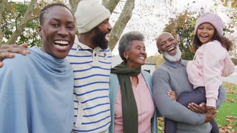 video of happy african american parents with grandparents holding granddaughter in garden