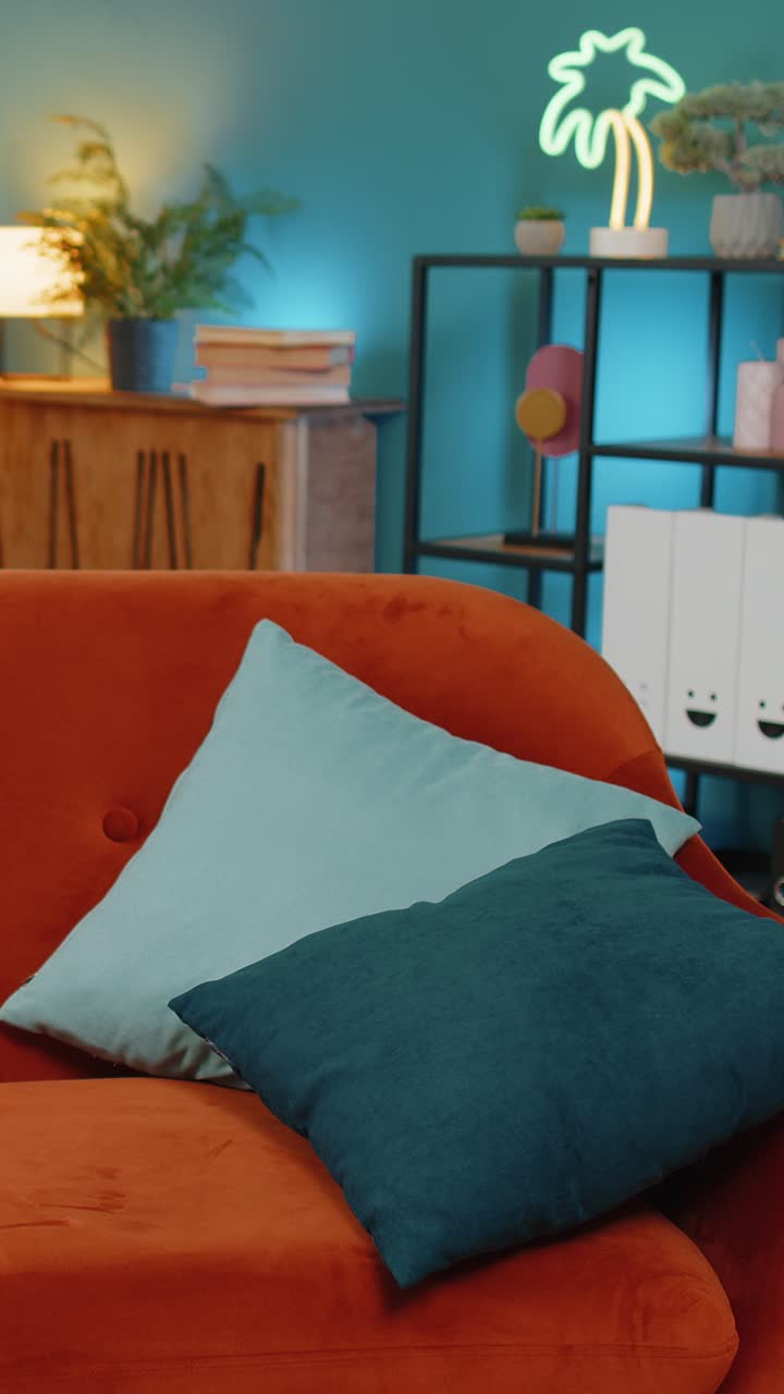 Tired young woman lying on sofa taking rest at home falling asleep on comfortable couch with pillows