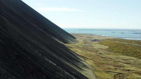 Scenic-black-volcanic-mountainside-in-rugged-Iceland---aerial-dolly