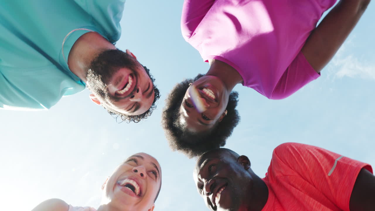 Diverse Group of Friends Smiling and Laughing Together Under Blue Sky