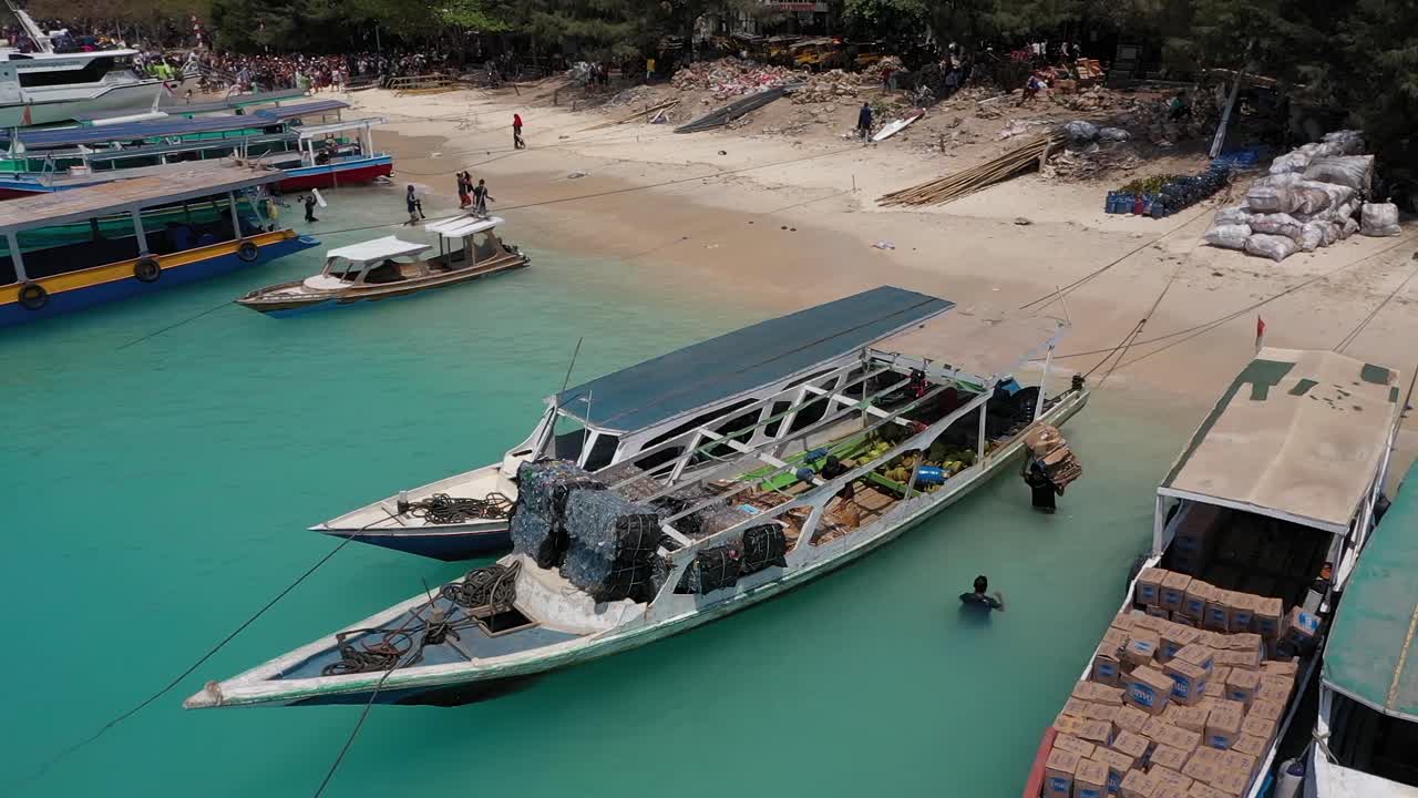 Trash For Recycling Loaded Onto Boat By Local Garbage Workers In Gili Trawangan Island, Indonesia - Drone Shot