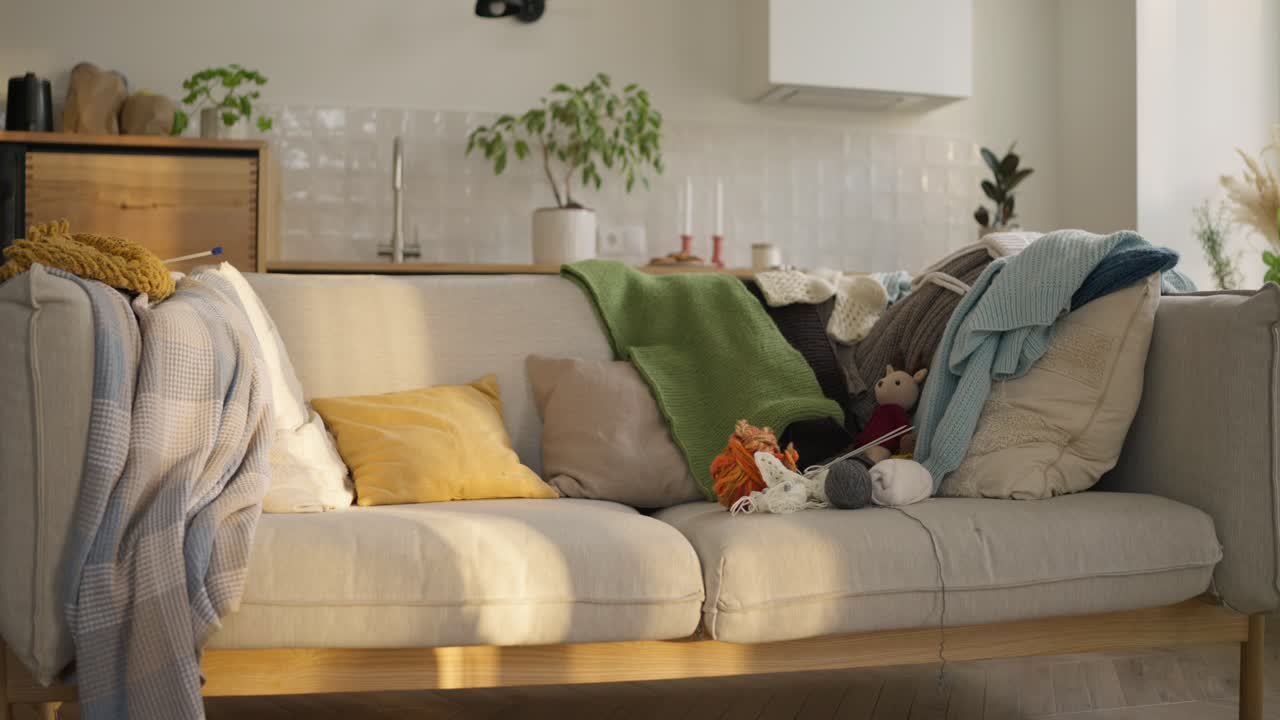 Cozy Living Room with Knitted Blankets and Yarn