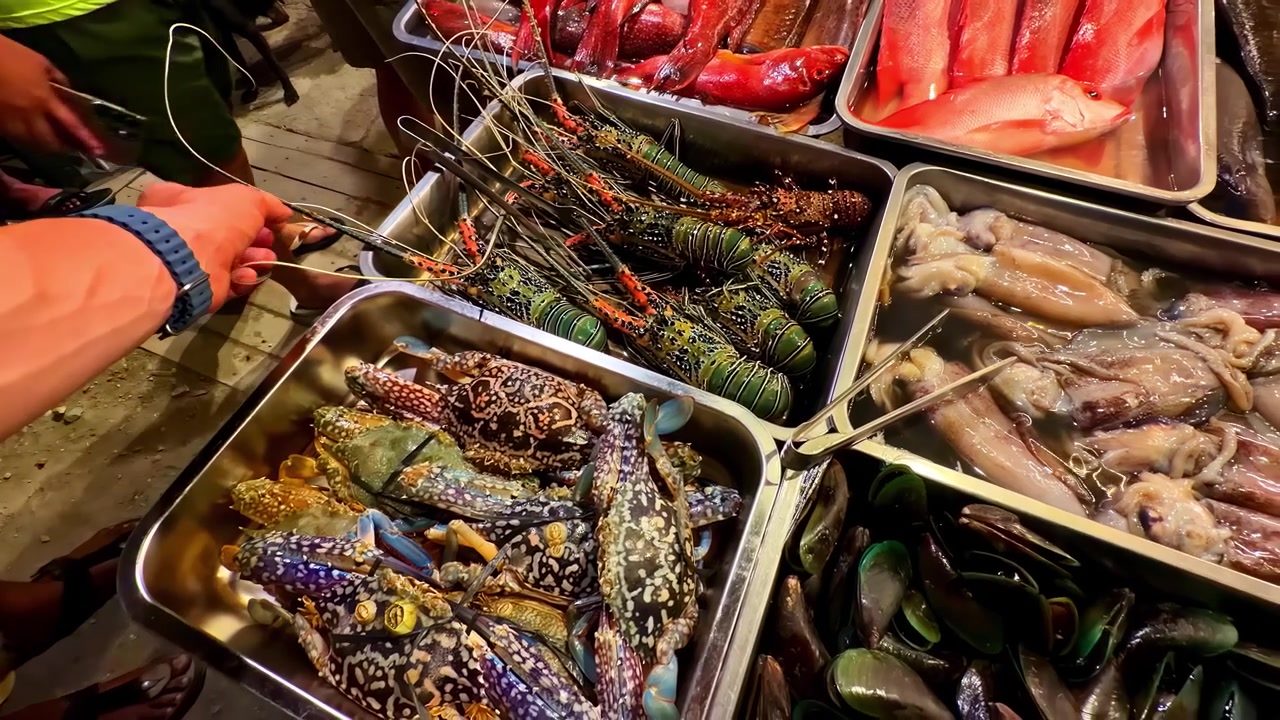 Fresh seafood displayed on market table with fish and shellfish in Port Barton Philippines