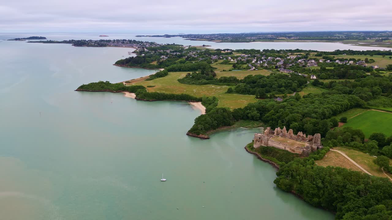 Historic ruins of Château du Guildo castle at mouth of Arguenon river, Brittany coastline, Saint-Jacut-de-la-Mer, France. Aerial drone orbiting