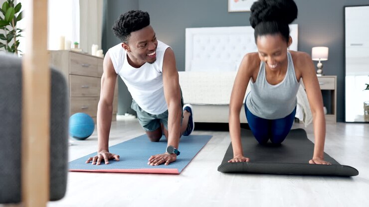 Young couple in their home doing cardio