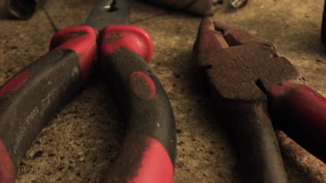 old tools on desk, meter, screwdriver, grippers, hummer and bolts macro shot