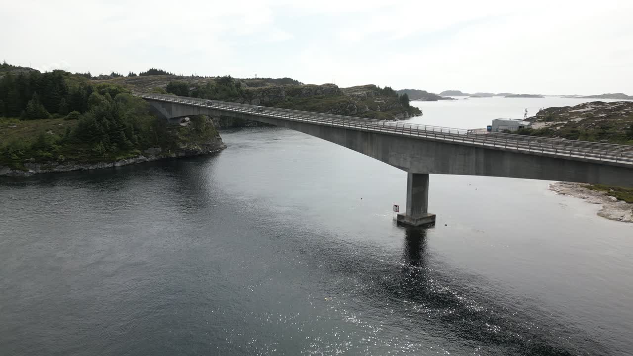 Cars Driving over Svelgen Bridge in &Oslash;ygarden, Norway near Bergen with Scuba Divers under the Bridge