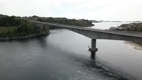 Cars-Driving-over-Svelgen-Bridge-in-Øygarden,-Norway-near-Bergen-with-Scuba-Divers-under-the-Bridge