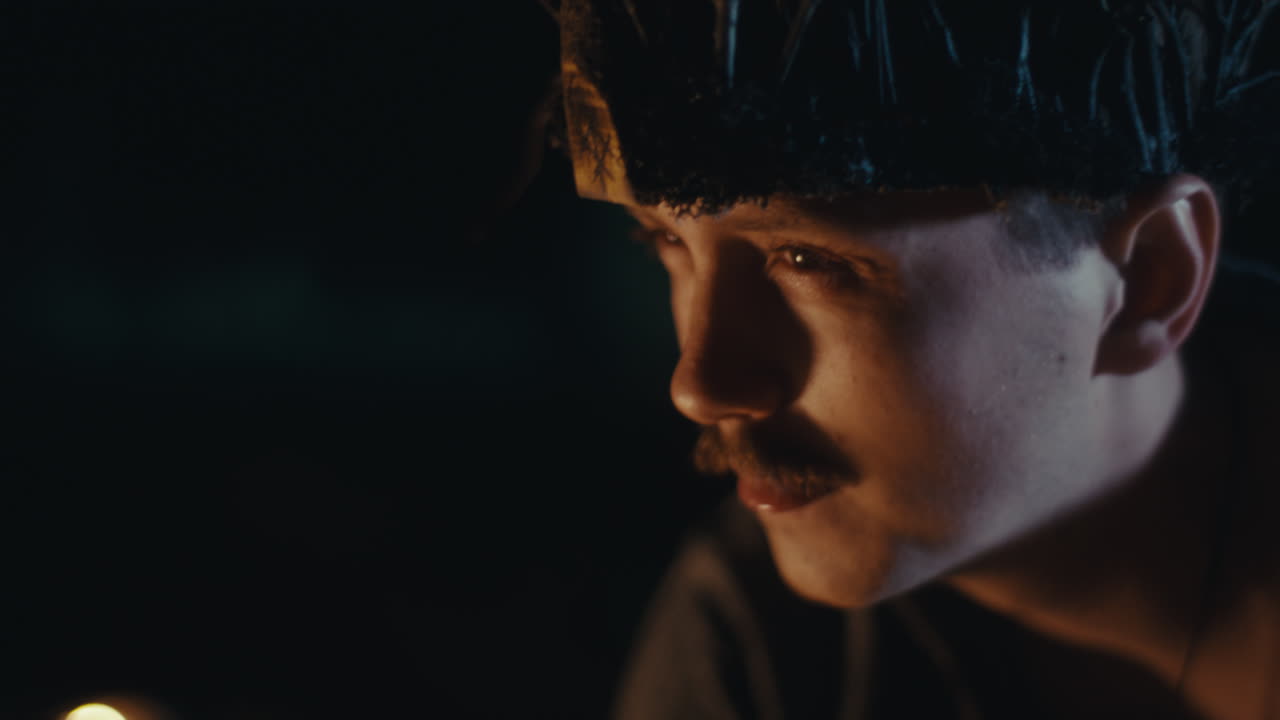 Contemplative Man Wearing a Branch Crown in Firelight