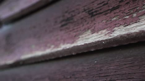 slow motion cinematic shot of elements of the walls of a wooden old village house and a wooden gate close-up