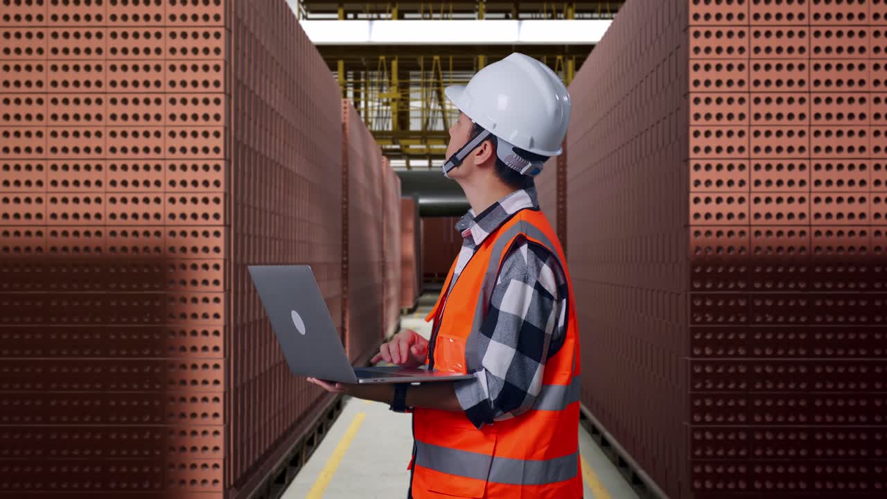 Worker inspecting bricks in a warehouse
