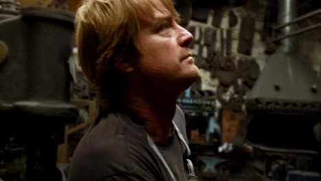 blacksmith wearing apron in workshop 4k
