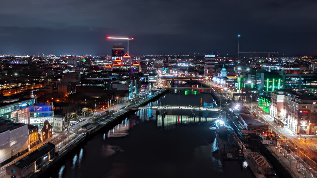 하이퍼 스 (aerial hyperlapse) 는 밤에 리피 강 (liffey river) 을 뒤집어서 다채로운 불빛으로 조명된 더블린의 활기찬 도시 풍경을 보여준다.