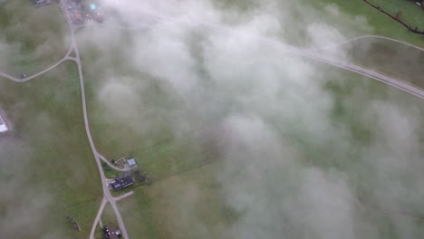 aerial view of rural foggy green european valley with little traffic