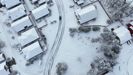 Top-down-drone-shot-of-a-neighborhood-covered-in-snow-and-ice