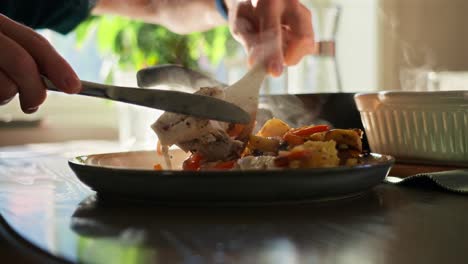 serving food in slow motion with peppers falling from above onto a plate of delicious food