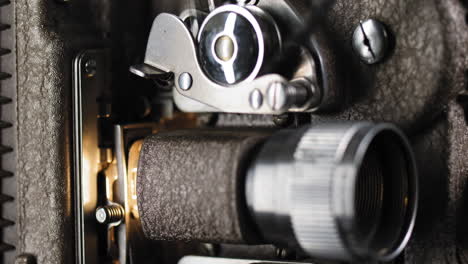 Macro-Shot-of-8mm-Projector-with-Film-Running-through-Gears