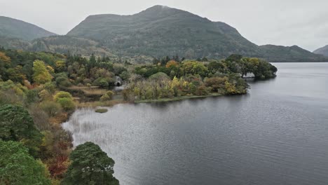 serene view of muckross house amidst tranquil lake and lush greenery