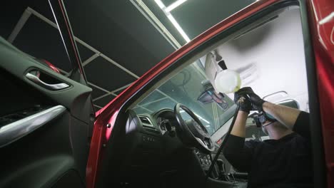 professional car cleaning. сar wash. interior detailing. dry clean and detail a car interior. deep seats cleaning. wiping foam in car wash. cleaning the car panel from dust. a vacuum cleaner