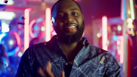 African-american-guy-posing-at-party.-Handsome-man-playing-around-in-club