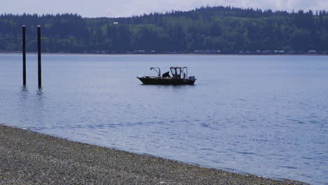 small, nondescript fishing floating near dock at camano island state park, wa state 10sec-60fps version 3