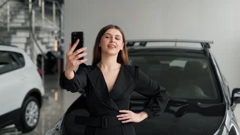 Hermosa-Joven-Tomando-Un-Selfie-En-El-Fondo-De-Un-Auto-Nuevo-En-Un-Concesionario-De-Autos