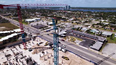 Aerial-view-around-cranes-in-sunny-Daytona-beach,-Florida,-USA---orbit,-drone-shot