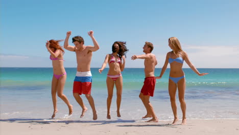 Happy-friends-jumping-at-the-beach