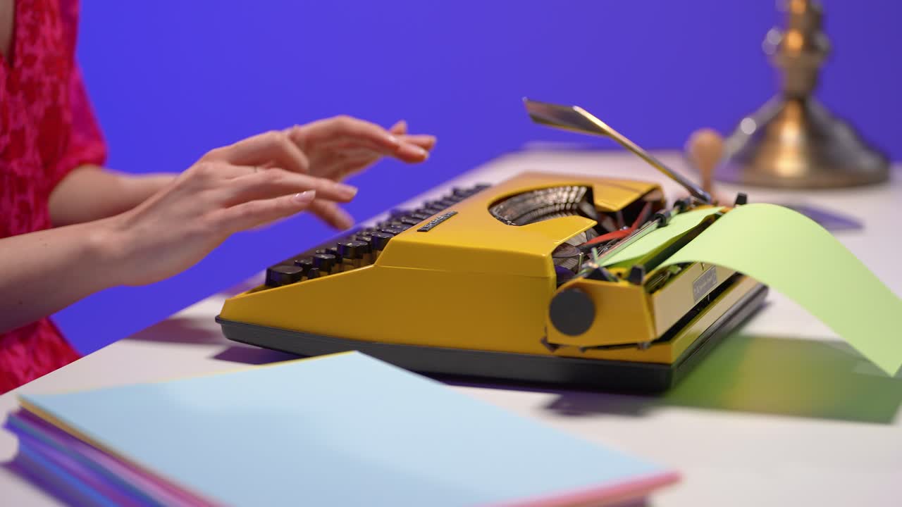 Close-up of a woman typing on a yellow typewriter with green paper in a vivid retro-themed office. The scene blends nostalgic design, analog tools, and focused creativity in a stylish workspace